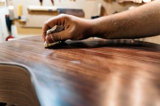 Close up of man working on wood stain