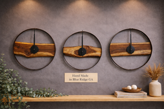 Three wooden wall clocks on a gray wall with decorative elements below.
