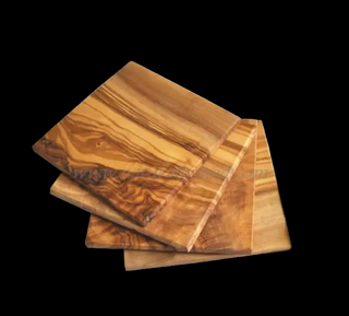 four wooden coasters stacked on a white background
